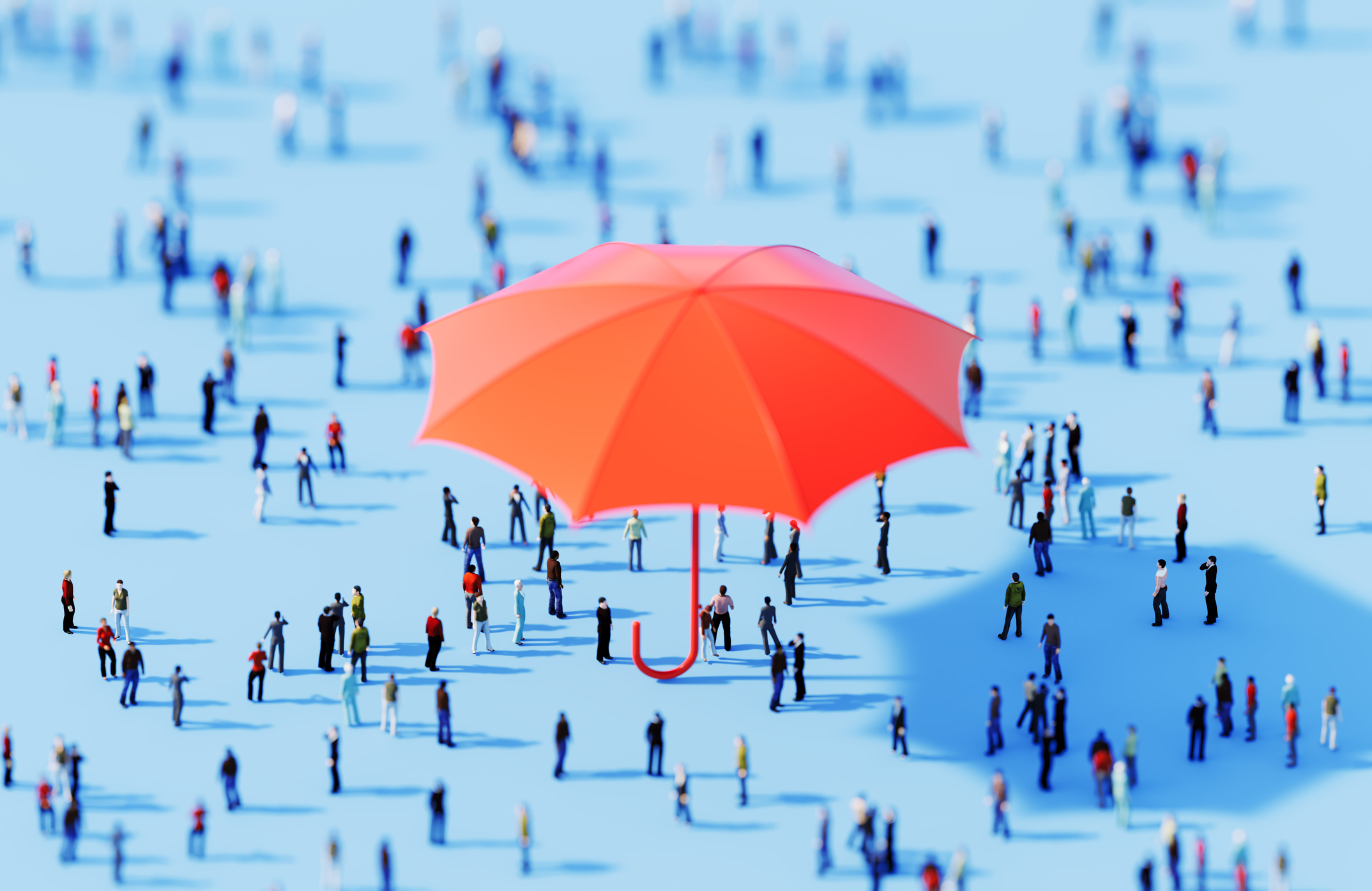 Large red umbrella covering small people