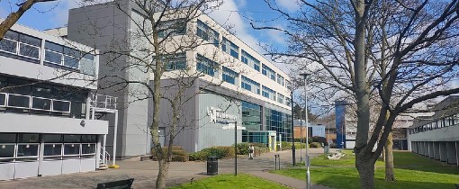 Exterior of a building on Walsall Campus, the University of Wolverhampton branding on the side of the building