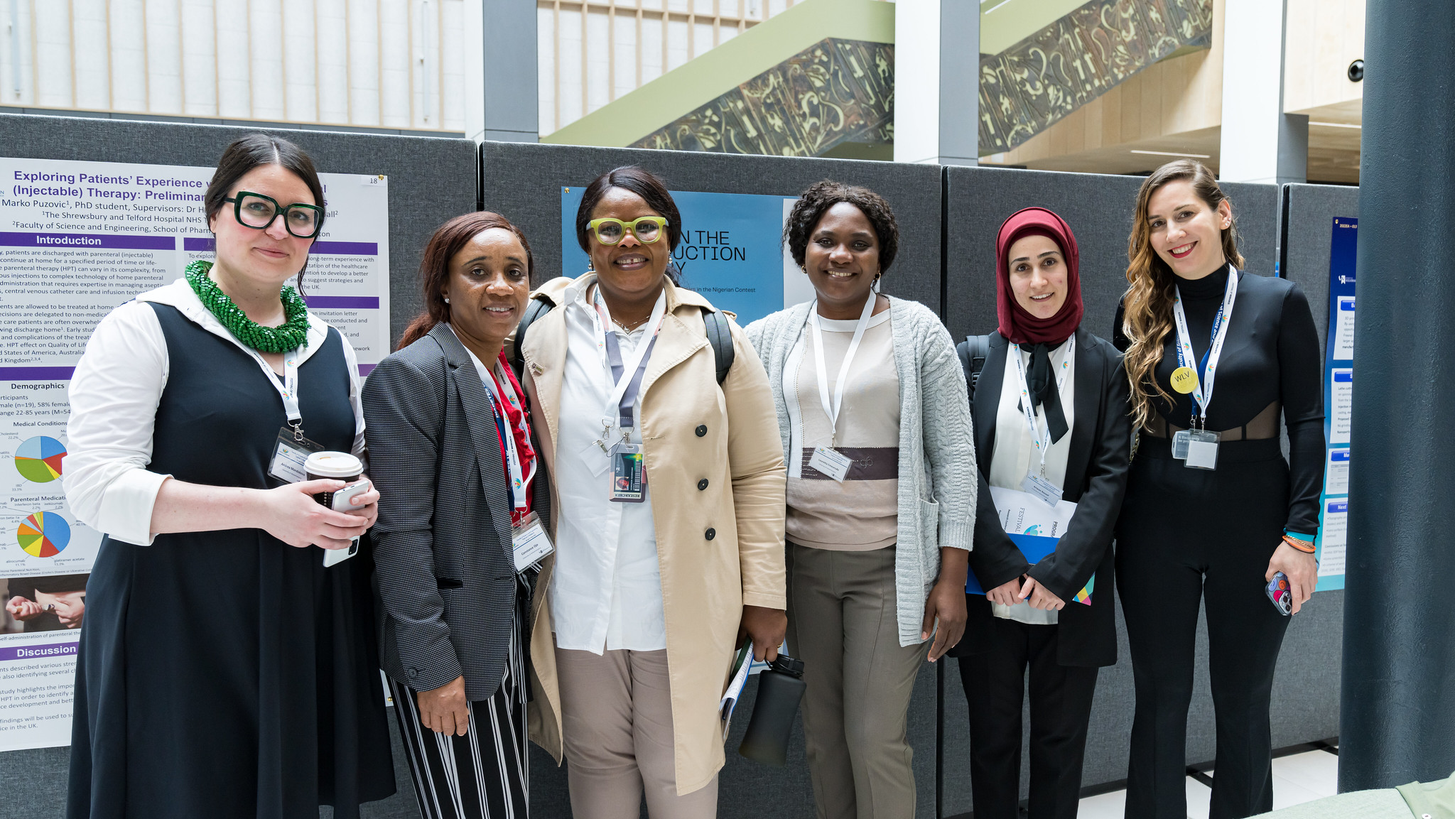 Photograph of women from global majority backgrounds standing together in front of a display at Springfield Campus.