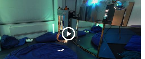 A room with lights and made up beds on the floor