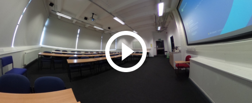 a lecture room, with tables and chairs