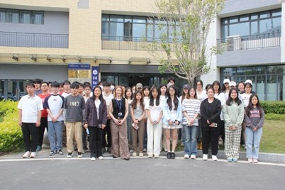 a female lecturer stands in front of a class in china