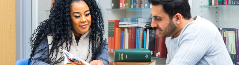 two students read a book