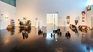 Photograph of various artworks, including sculptures paintings, photographs and installations, on display at the New Gallery Walsall during the MA Fine Art exhibition