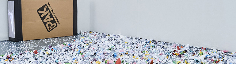 Fine Art graduate's Installation artwork containing a large cardboard box displayed on a bed of multicoloured scrunched up paper