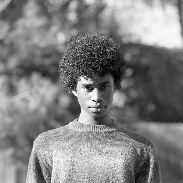 Black and white photograph of a person wearing a jumper.