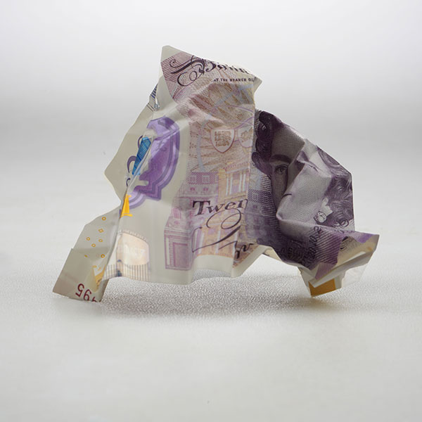 Photograph of a £20 note creased into a ball.