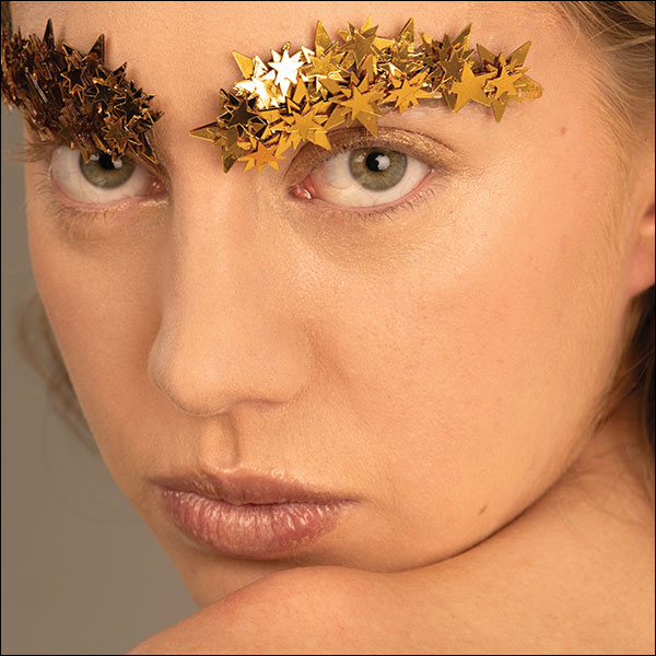 Cover of OFF TOWN Fashion and Life magazine, a heading below a photograph of a person with bejewelled eyebrows reading ECLIPSE IN THE BROW.