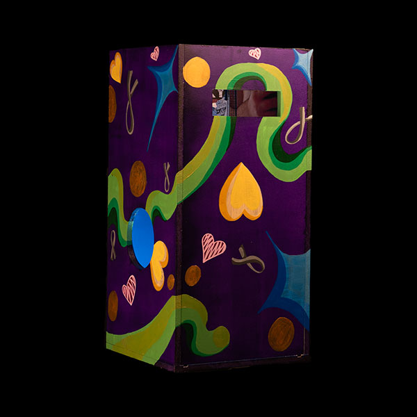 A folding wall painted purple with hearts, stars and ribbons.