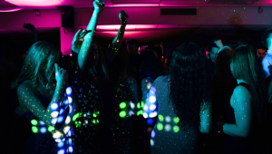 A club in Walsall with small coloured lights shining onto a crowd of dancing patrons in the dark