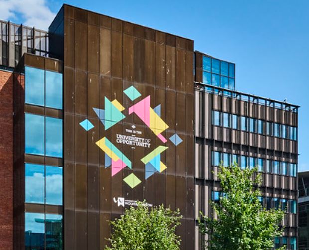 Image of the Rosalind Franklin building at Wolverhampton City Campus, UNIVERSITY OF OPPORTUNITY written in the middle of a logo on the side of the building.