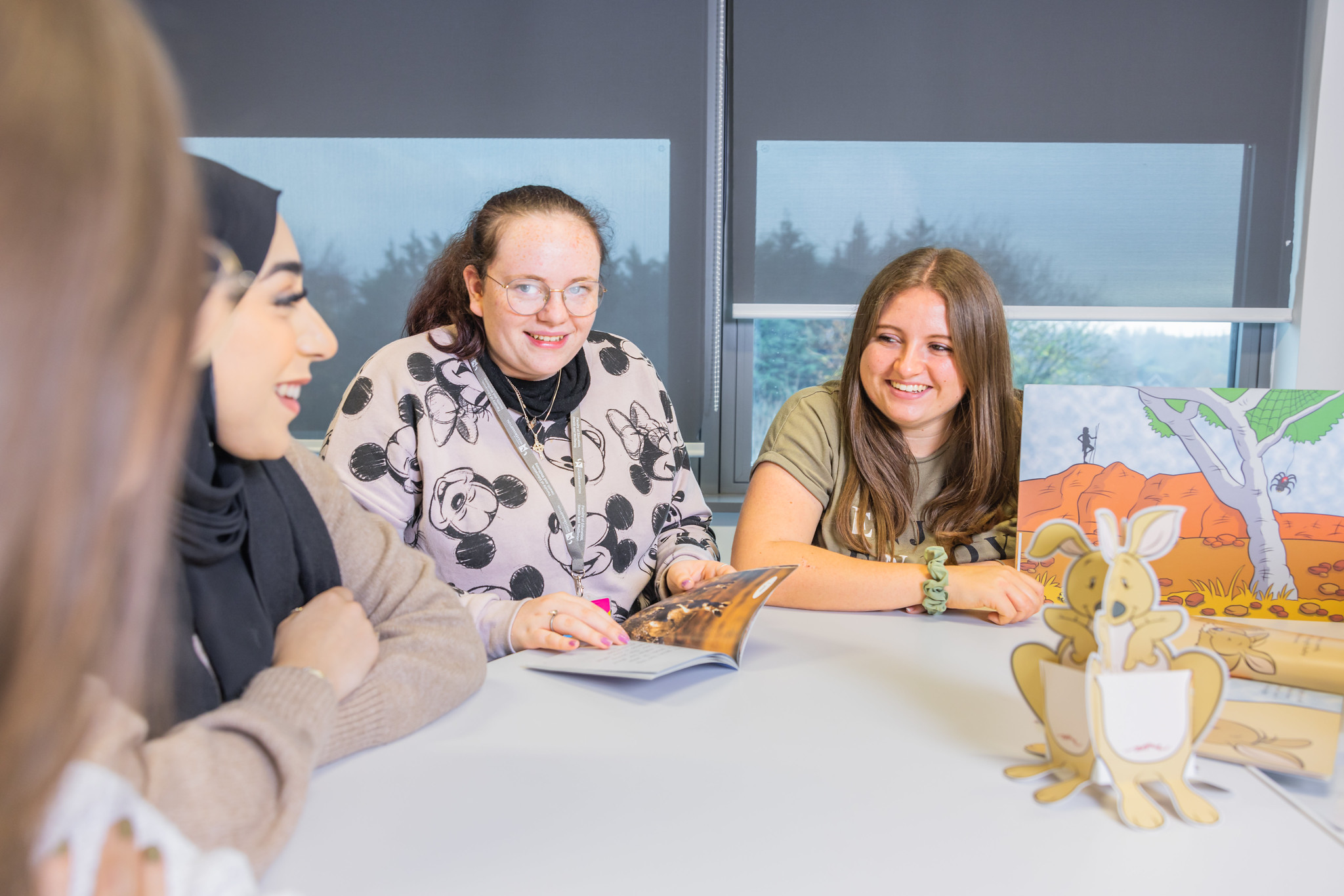 Teaching staff sat around a table in discussion