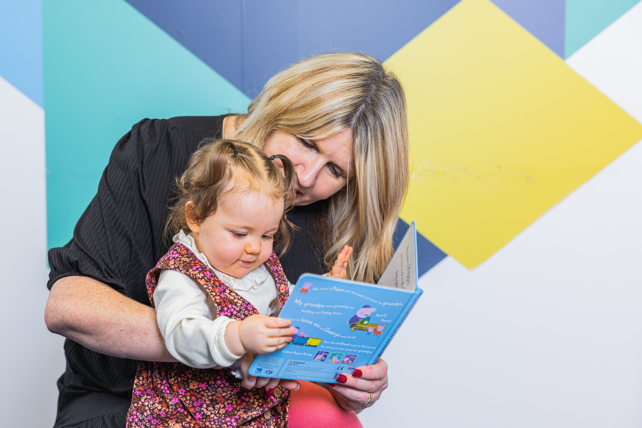 A teacher helping a child to read