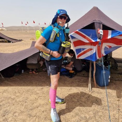 Image of Nigel Watson, Redditch runner with prostate cancer who completed the Marathon des Sables, showing him standing outside in sporting gear with the Union Flag