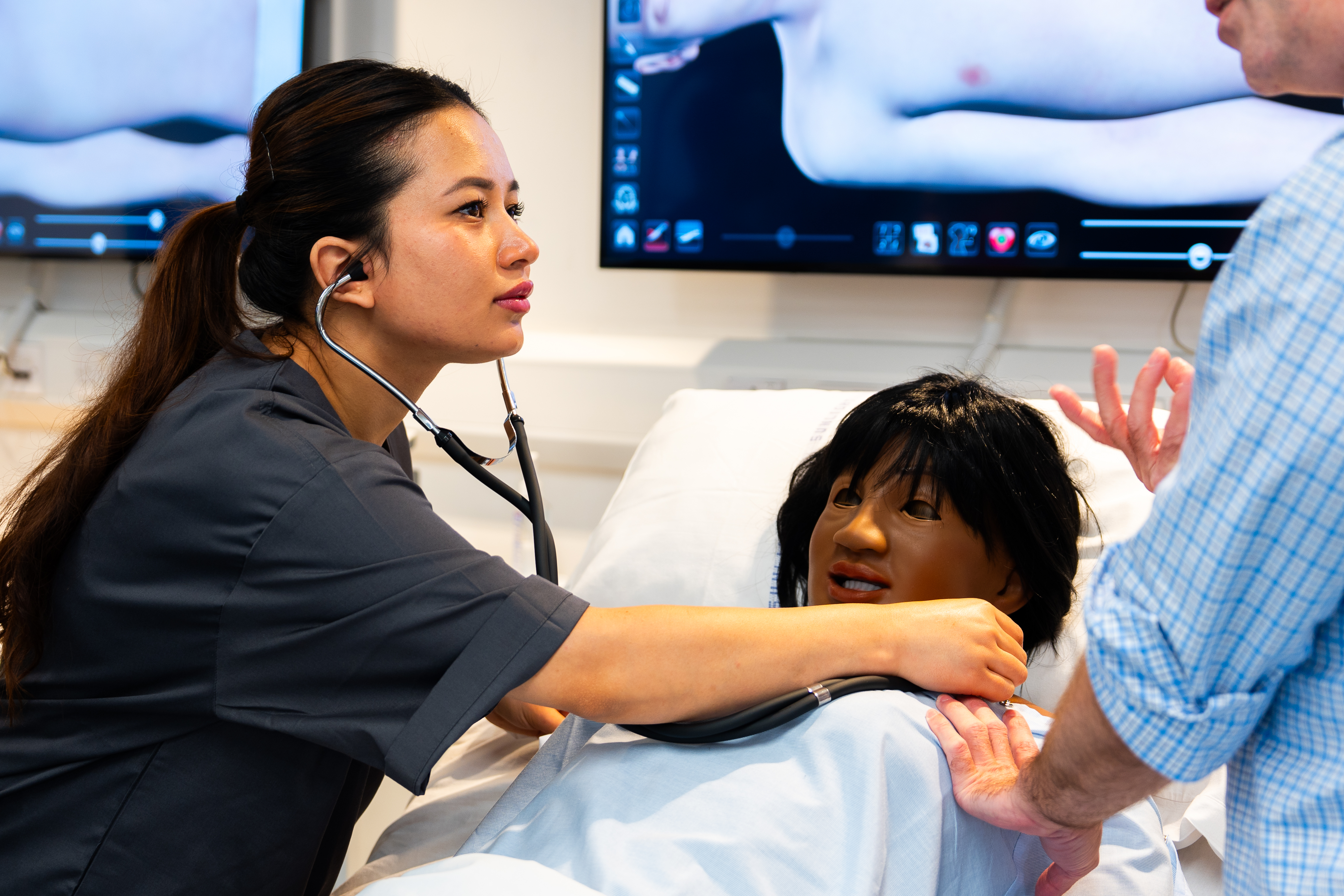 A nursing student attending a mock patient