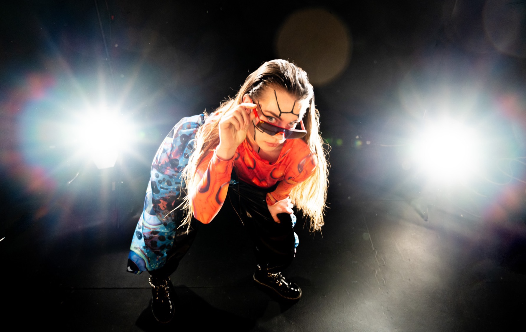 a woman squatting with sunglasses