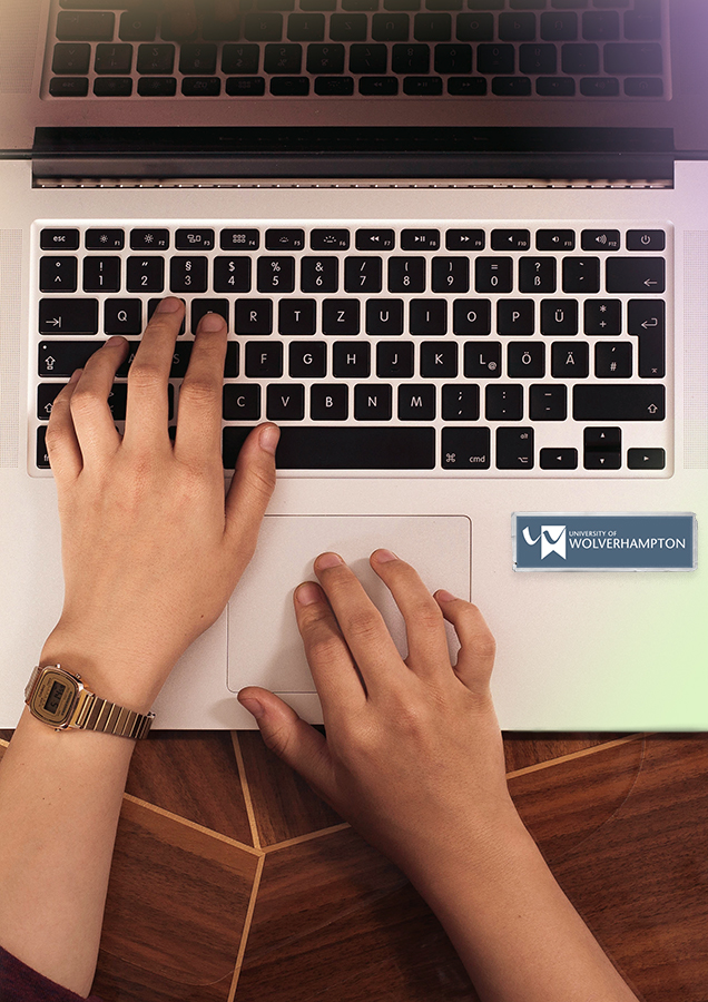 hands typing laptop