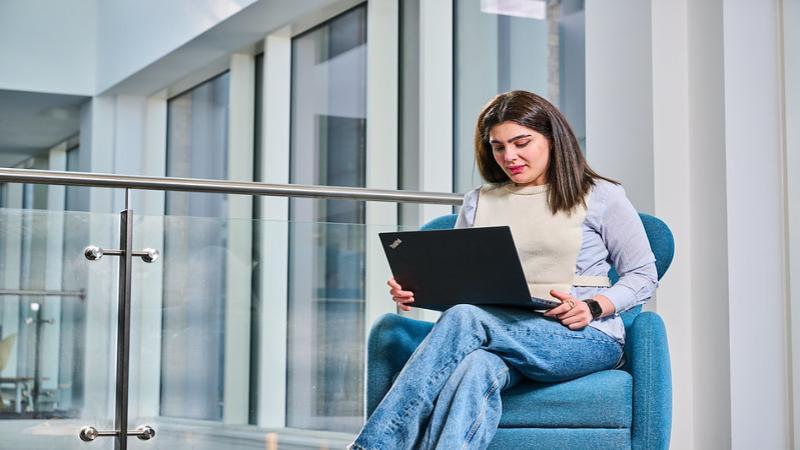 Woman sitting with laptop open