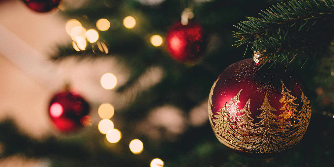 red baubles hanging on a Christmas tree