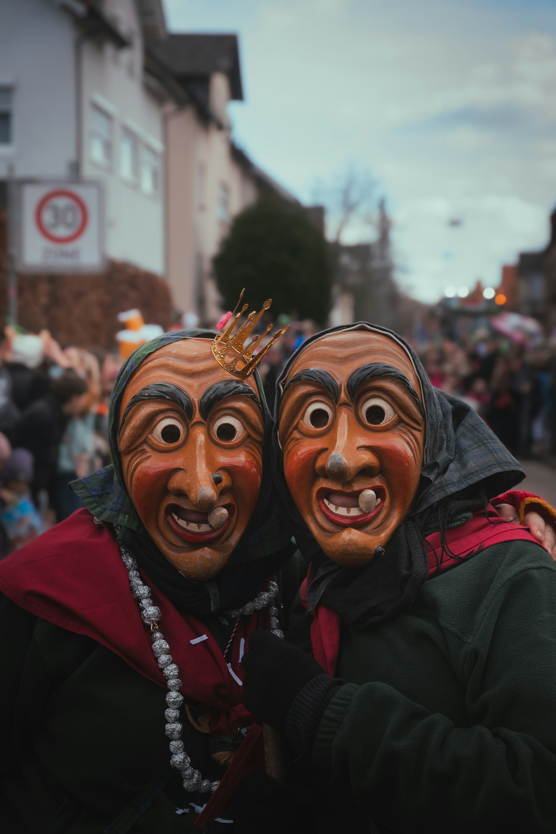 Two people wearing identical masks in the street