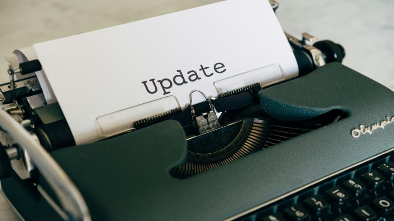 A typewriter with a piece of paper with update written on it