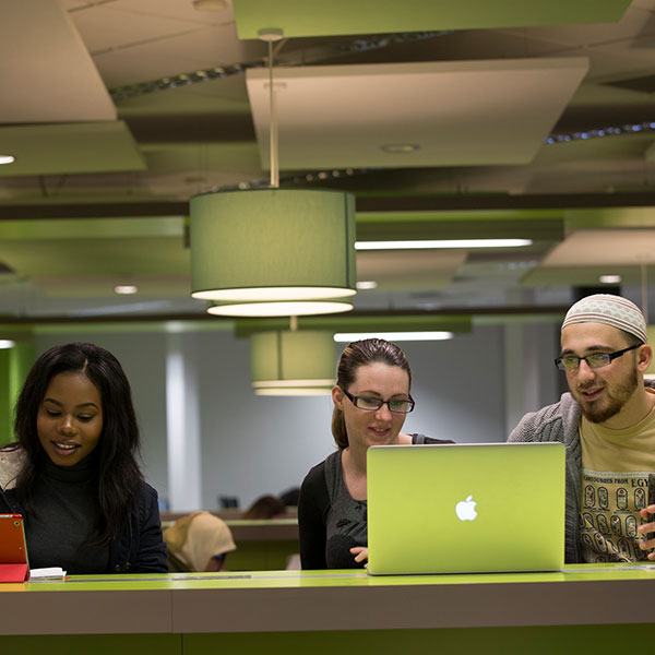 Three students and laptop