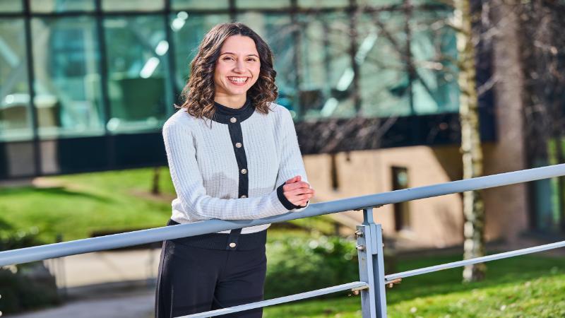 A photo of a student smiling on campus