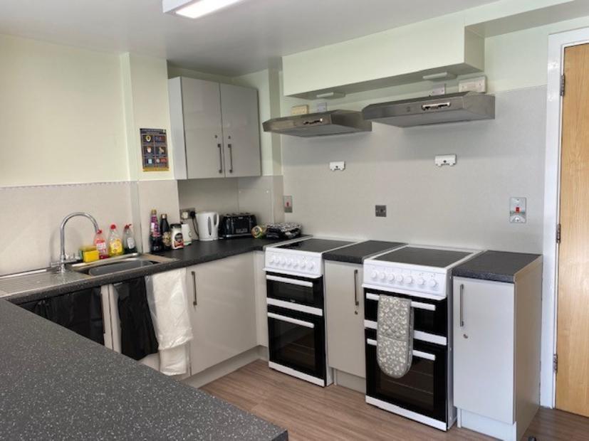 Kitchen in Walsall Campus accommodation, a countertop with a sink, two ovens and a number of cupboards