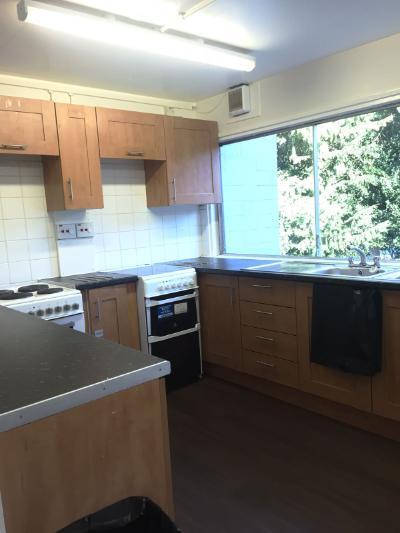Image of a kitchen in Gorway accommodation, showing countertops, cupboards, ovens and windows