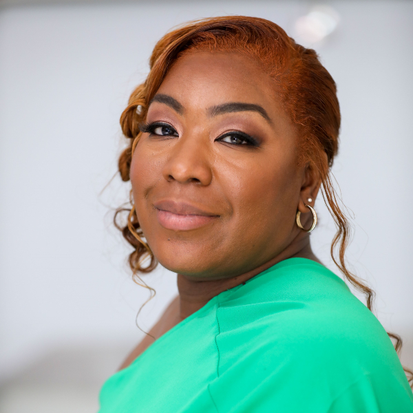 Side-on photograph of Chantel Brooks in a green outfit.