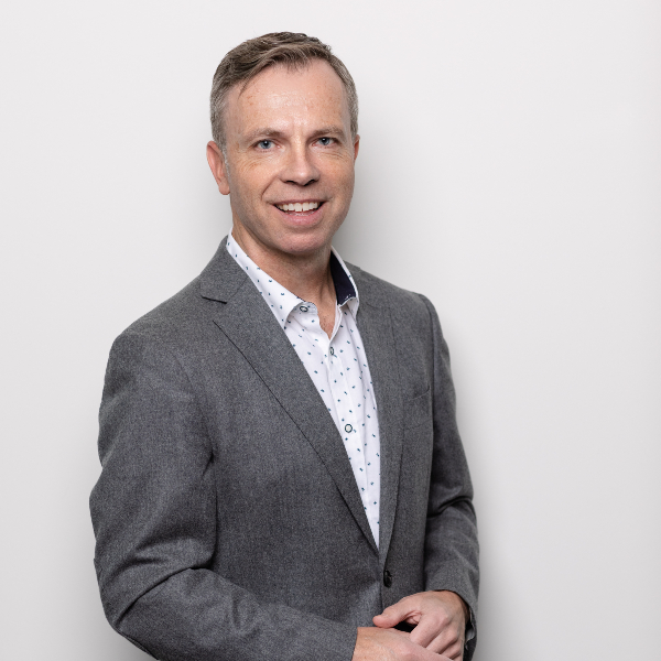 Graham Turner in a white studio wearing a grey suit.