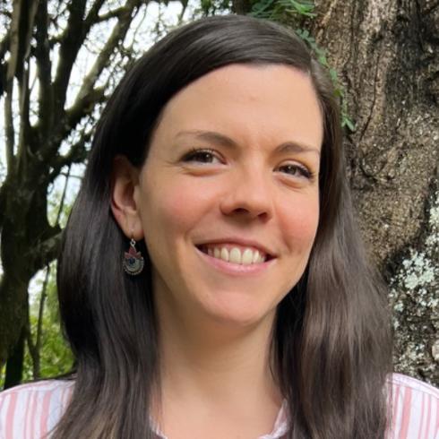 Photograph of Ljubica Butkovic standing amongst trees and foliage.
