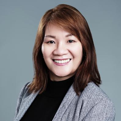 Nely Stephanie Nasir wearing a grey blazer over a black shirt.