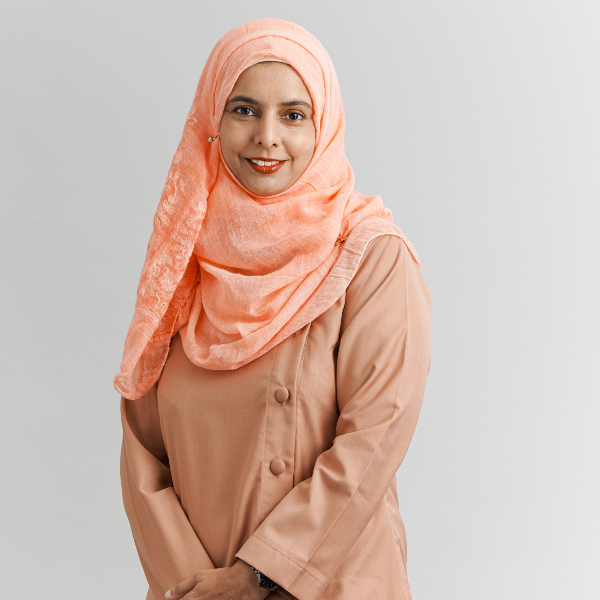 Razwana Begum Abdul Rahmin posed for a photograph in a white studio, wearing a peach-coloured headscarf.