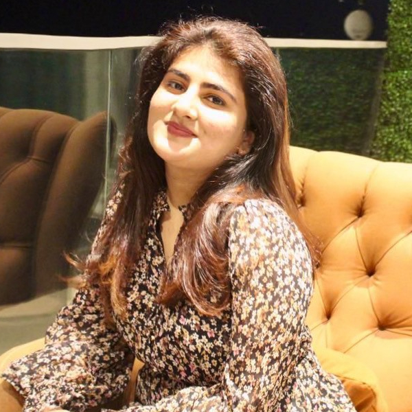 Soniya Nigam sitting in an armchair facing the camera.