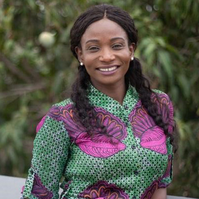 Profile photo of University of Wolverhampton alum Fatou Baldeh. Fatou is smiling and wearing a green and purple dress.