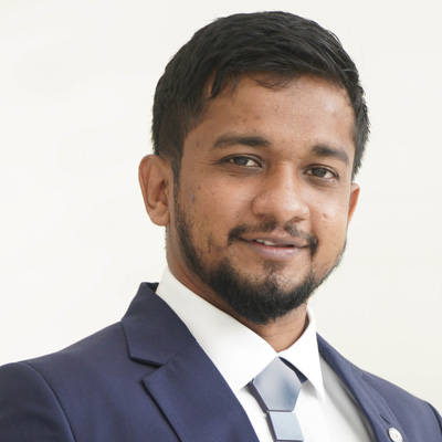 Profile photo of University of Wolverhampton alum Sadham Zarjahan. Sadham is wearing a white shirt, navy suit jack and light blue tie.