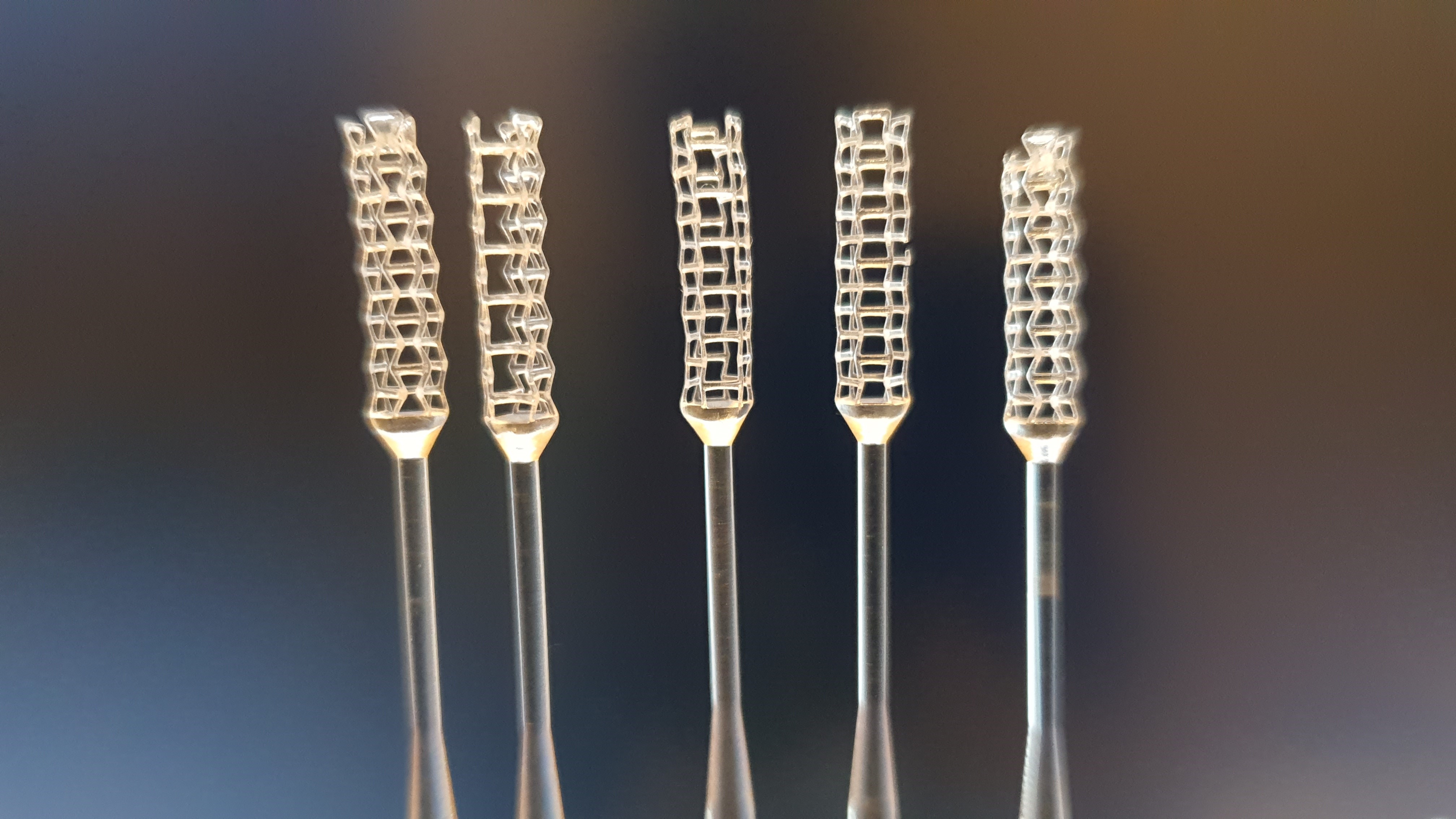 Close-up photograph of the heads of five 3D-printed swabs.