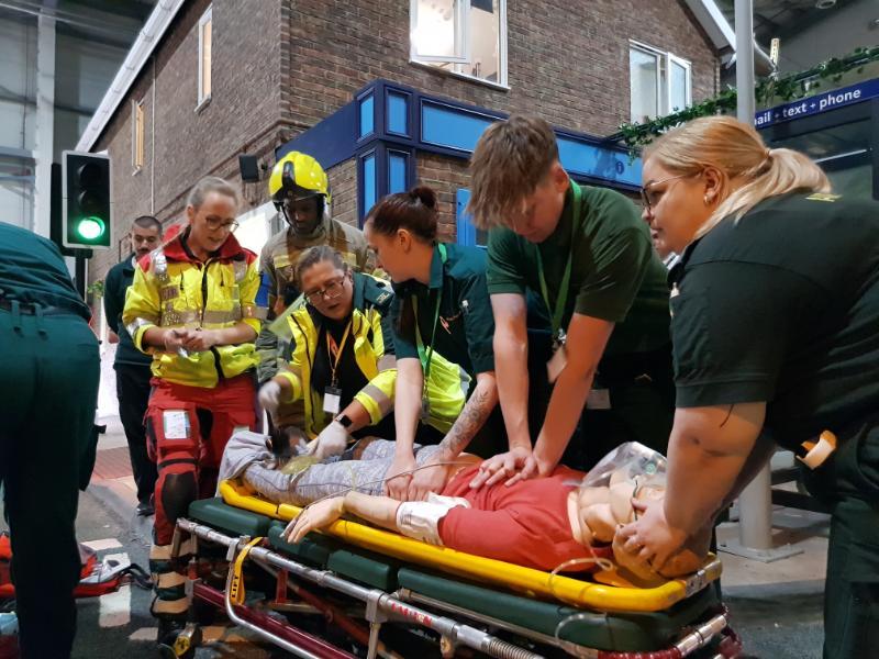 Paramedic students working at a simulated critical care exercise