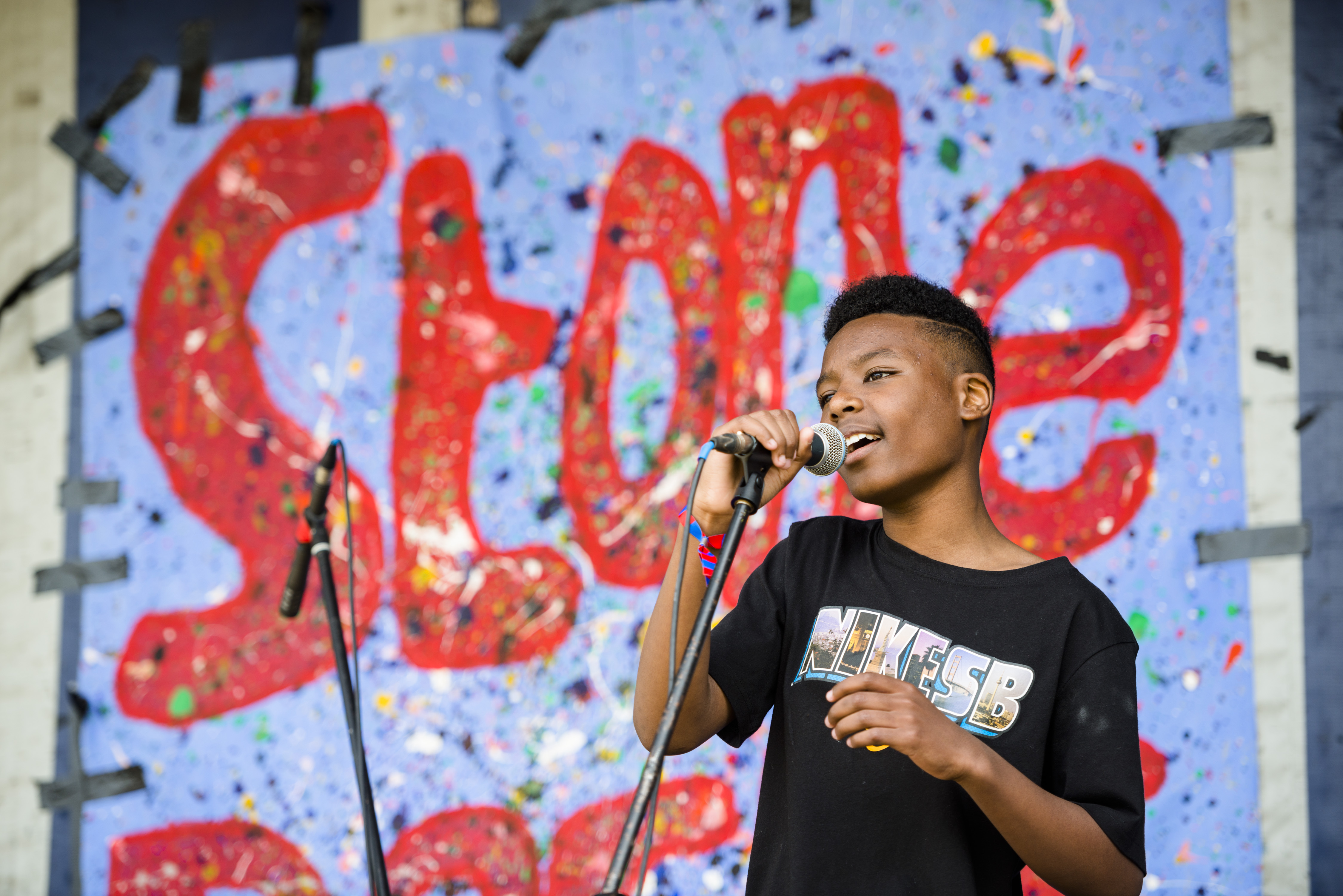 Boy singing with microphone in his hand