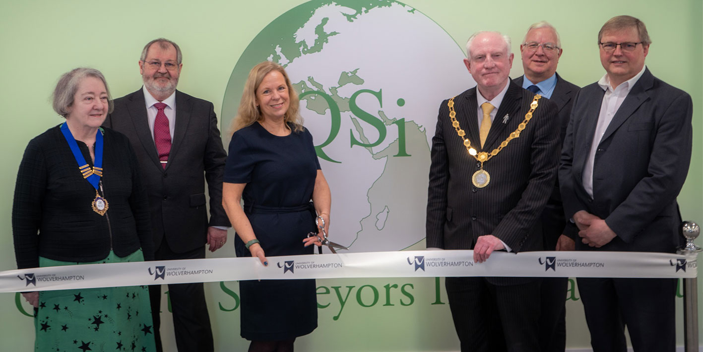 Group of representatives cut the ribbon for an official room opening