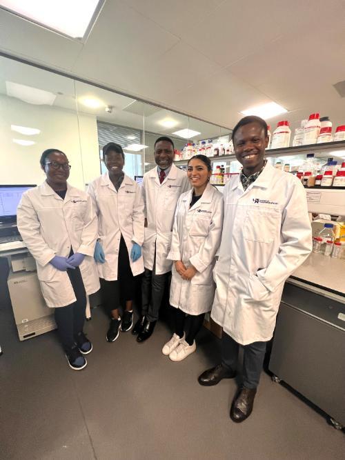Group of PhD research students and academic in a laboratory