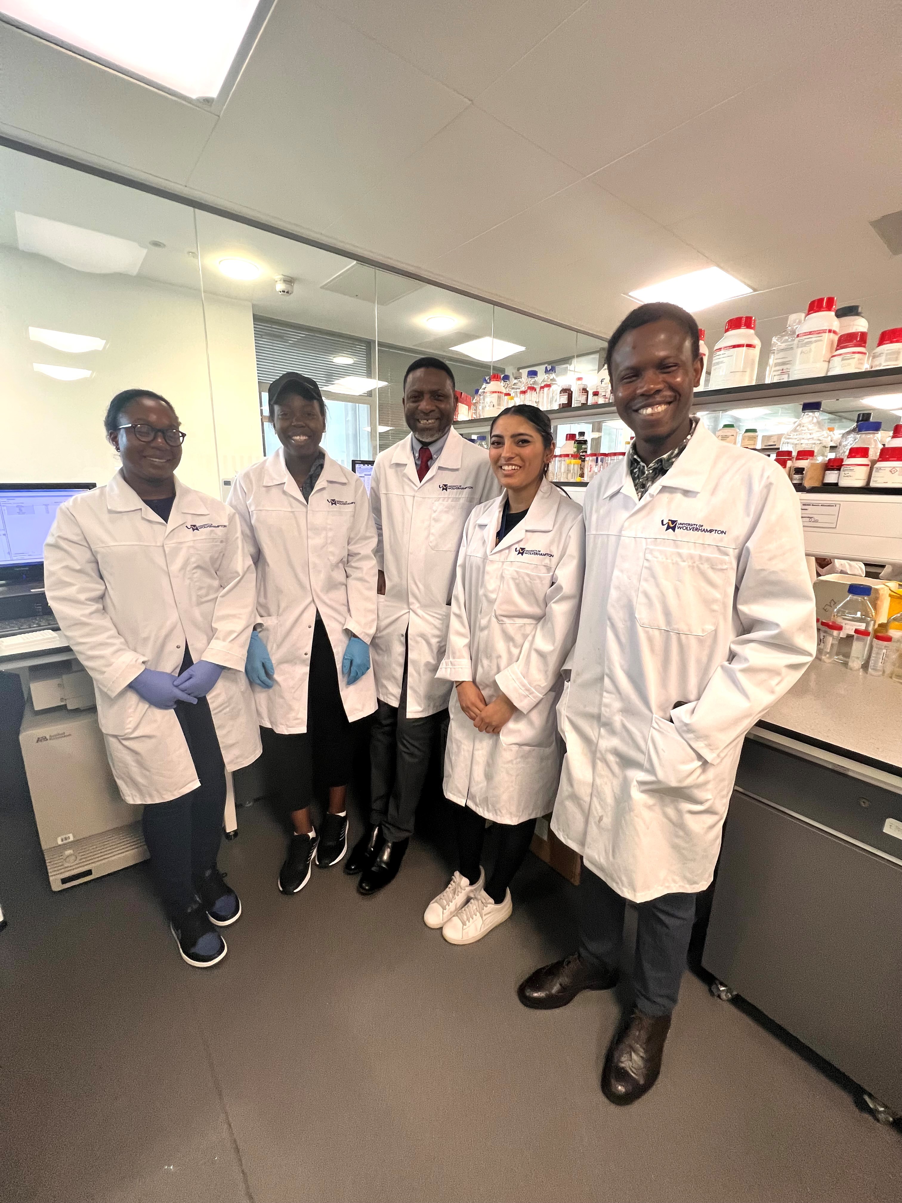 Group of PhD research students and academic in a laboratory