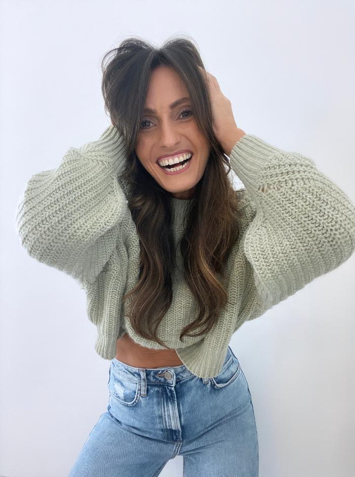 A University Alumnas touching her head promotional picture