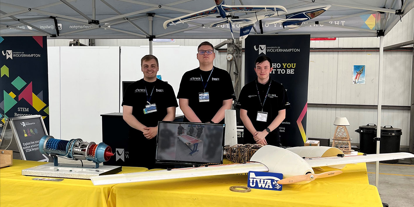 Three Aerospace students displaying work at RAF Cosford