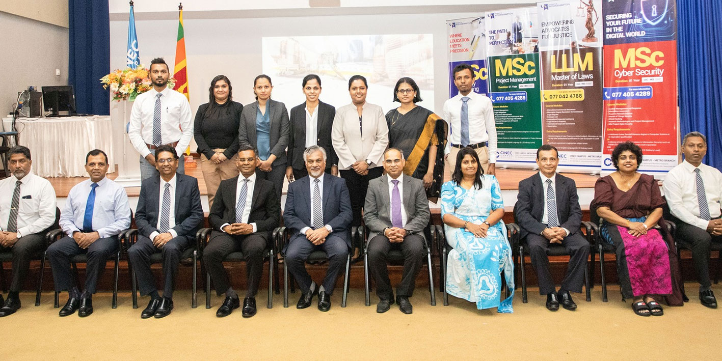 A group of attendees sitting and looking at the camera at the launch event for new degrees