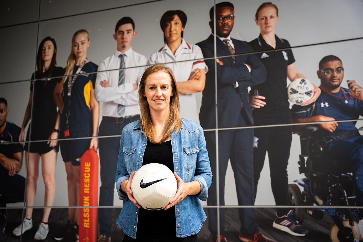 Kerys Harrop former Lioness holding a football in front of WLV Sport centre