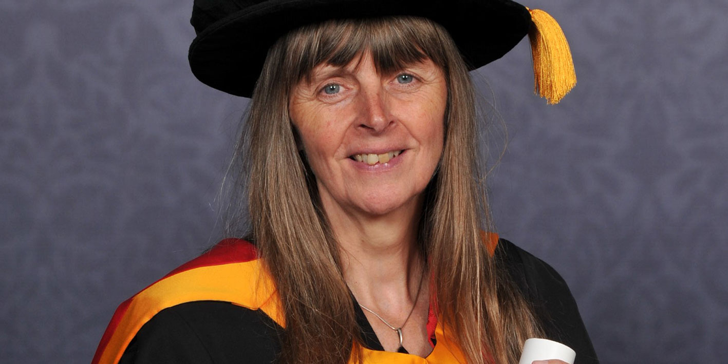 Honorary Graduate Emma Purshouse holding her award