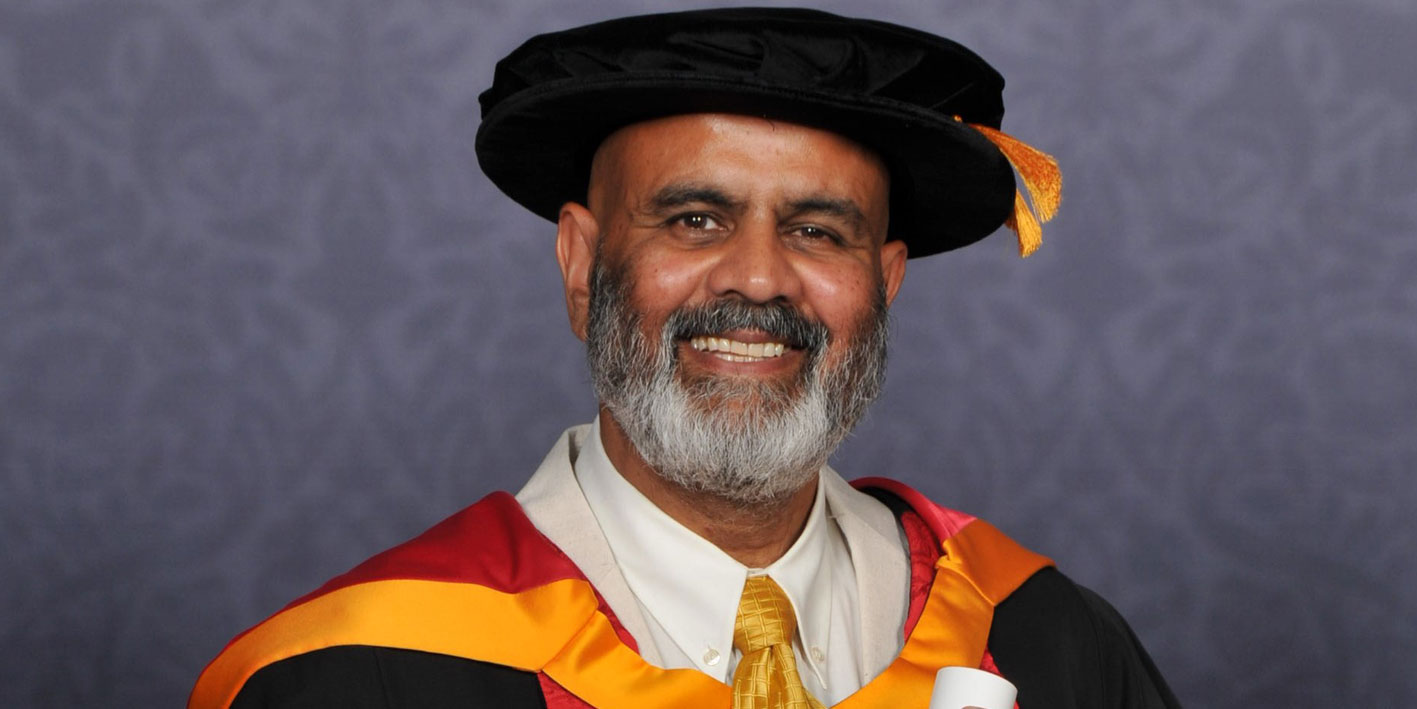 Portrait of Honorary Graduate Peter Chand smiling at the camera