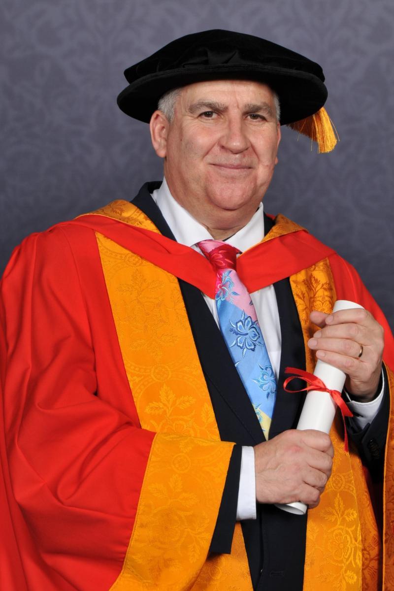 Portrait of Honorary Graduate Lewis Power with his award